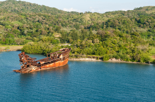 The rusty hulk of a ship run aground on the island of Roatan, Honduras