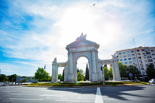 Majestic San Vicente Gate in Madrid with Roundabout on sunny summer day and city street view
