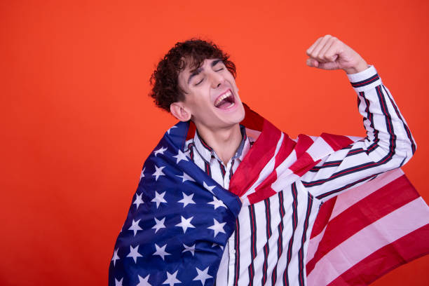 istock Young attractive guy with usa flag. 1582992379