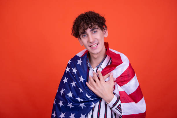 istock Young attractive guy with usa flag. 1582992720