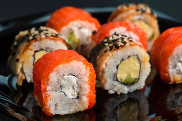 istock Traditional fresh japanese sushi rolls on a black background 1582993243