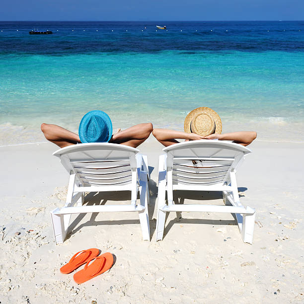 Couple on a beach Couple on a tropical beach flip flop sandal beach isolated stock pictures, royalty-free photos & images