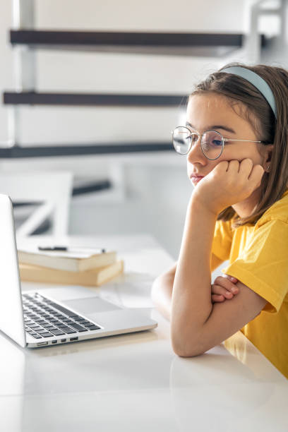 istock Exhausted schooler girl suffering from doing homework, tired from studying. 1583031077