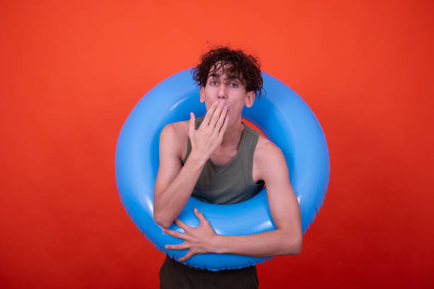 istock Funny guy on vacation. Orange background. 1583040313