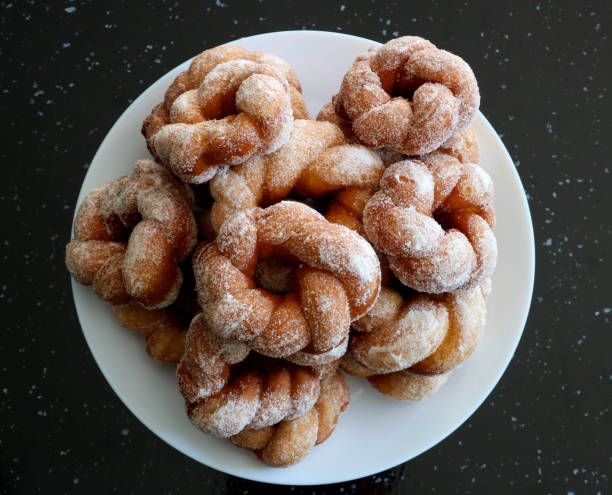 istock Freshly Made Donuts on a White Plate on a Black Granite Table Top 1583046988