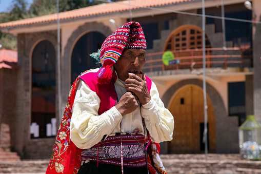 Taquile, Peru; 1st January 2023: Locals from the island of Taquile in Peru dancing and playing music at an event in the main square of the island.