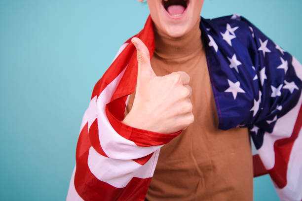 istock Young attractive guy with usa flag. 1583053510