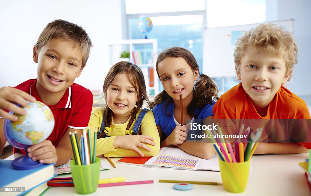 Group of pupils Group of diligent schoolchildren looking at camera in school Beautiful People Stock Photo