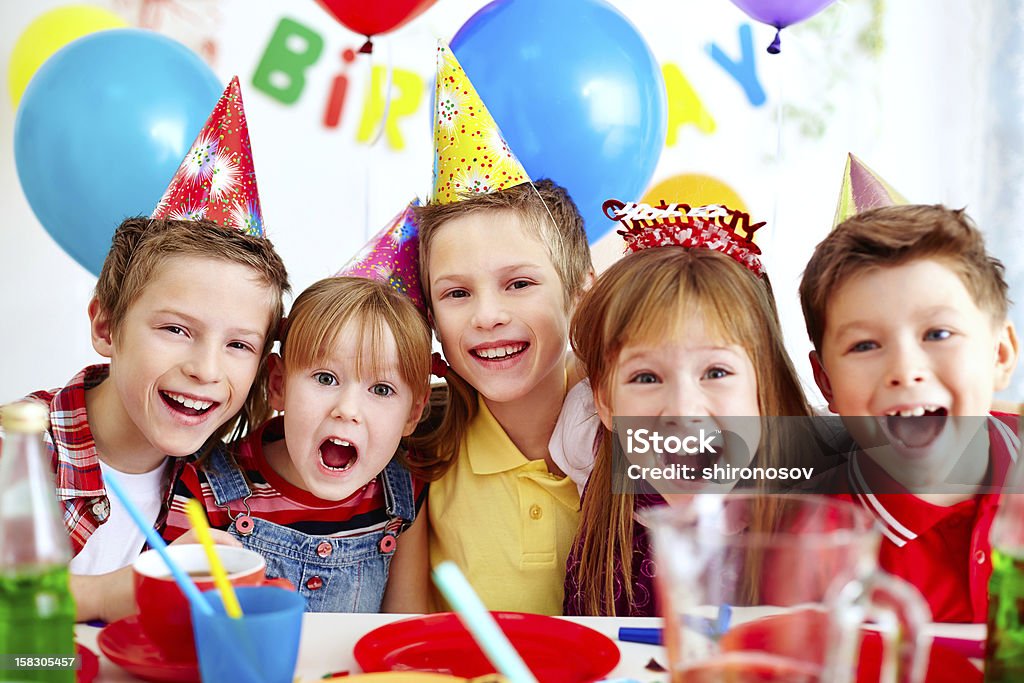 Group of friends Group of adorable kids looking at camera at birthday party Birthday Stock Photo