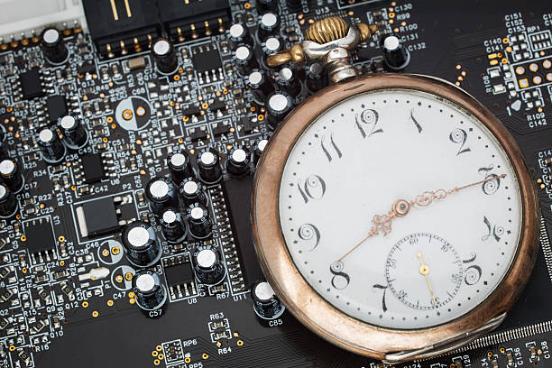 Old pocket watch on circuit board stock photo