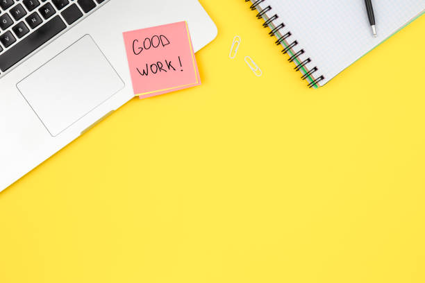 istock Laptop, notepad and paper reminder on yellow background, top view. 1583055823