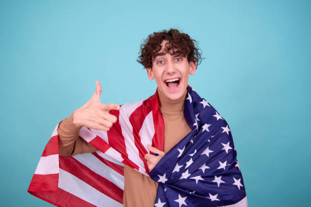 istock Young attractive guy with usa flag. 1583055914