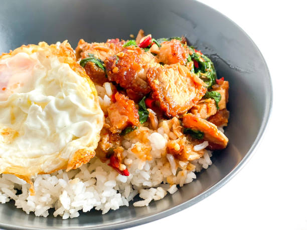 istock Rice topped with crispy pork belly with Thai basil and fried egg 1583056218