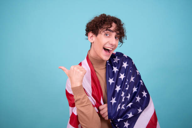 istock Young attractive guy with usa flag. 1583056437