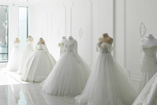 Beautiful wedding bridal dresses on mannequin in showroom in mall. Boutique wedding dress on mannequin in bridal store, fashion concept. bridal boutique stock pictures, royalty-free photos & images
