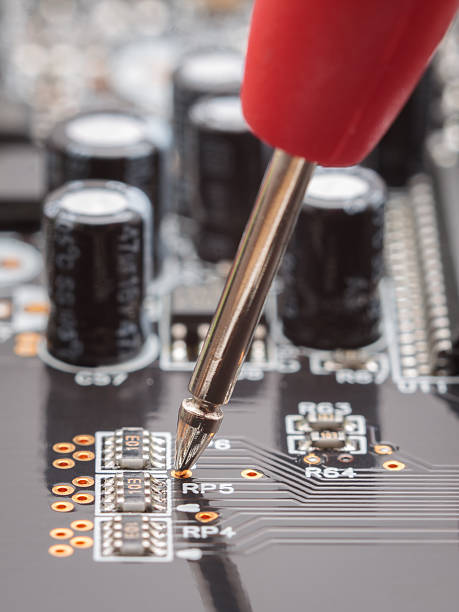 Measuring with probe on circuit board stock photo