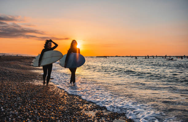 istock Two Young Female Surfers Having A Conversation Before A Sunrise Surf Session In Barcelona 1583061383