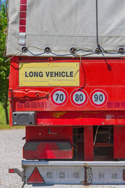 Stop Sign On Barricade Against Semi-Truck