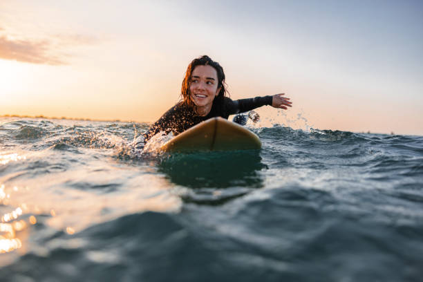 istock Professional Female Surfer Practicing Her Surfing During A Solo Surfing Session At Sunrise 1583063755