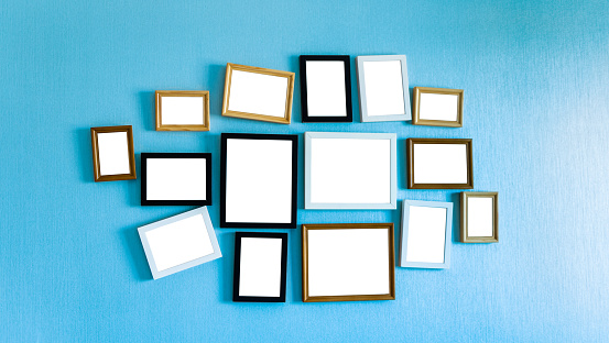 Group of picture frames on blue wall