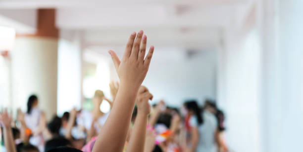 istock Group of happy children with their hands up 1583070056