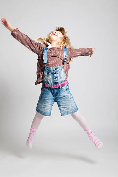istock Happy young girl jumping 158308519