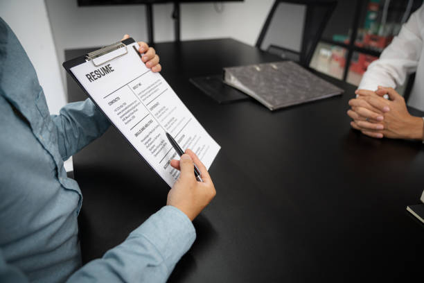 istock Examiner reading a resume during job interview at office Business and human resources concept. 1583095363