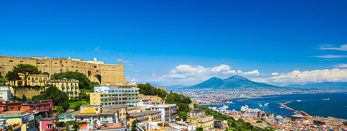 Naples, Italy. View of the city from above, with the Gulf of Naples and Mount Vesuvius. On the left the Hill of San Martino with Castel Sant'Elmo. Banner header image. 2023-07-04.