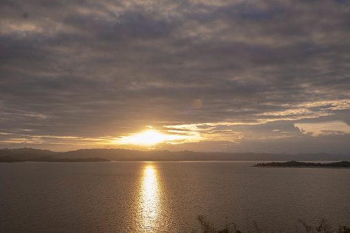 Travel for beautiful nature lake sunset, Relax vacation with landscape sky and evening sunlight, Calm outdoor holiday water reflection with cloud view background, peaceful calm horizon mountain