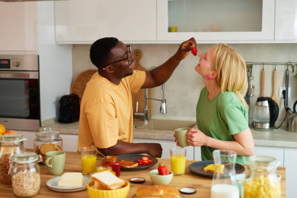 istock Multiracial couple enjoying breakfast together at home 1583104588