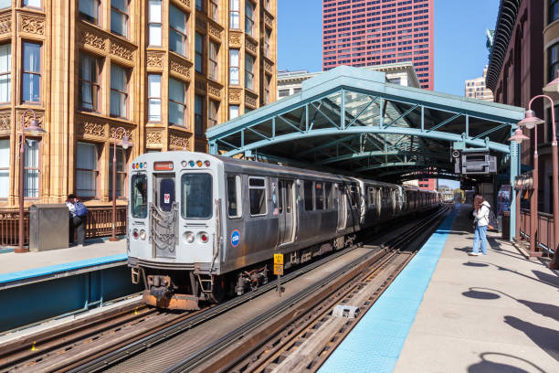 Train on elevated tracks within buildings at the Loop, Glass and Steel bridge between buildings, Chicago City Center, Chicago, Illinois, USA