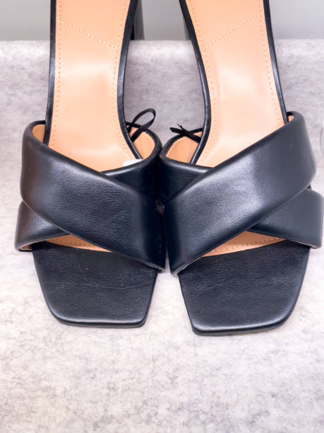 istock Elegant women's black sandals on gray background 1583160421