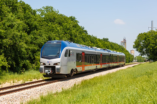 Grapevine, United States - May 5, 2023: TEXRail train operated by Trinity Metro commuter rail public transport with Stadler FLIRT vehicle in Grapevine near Dallas, United States.