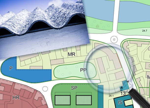 istock Mapping roofing with asbestos-containing material - concept with a magnifying glass against an imaginary city map 1583162136