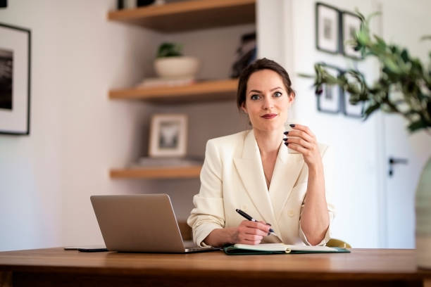istock Young businesswoman sitting at home and using laptop for work 1583164749