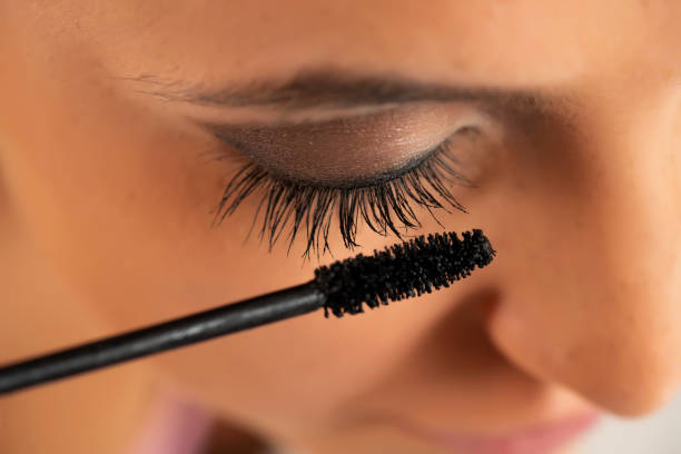 istock woman applying mascara 1583171337