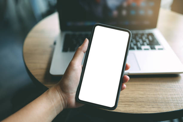 istock Women's hands holding cell telephone blank copy space screen. smartphone with blank white screen isolated on white background . smart phone with technology concept 1583174237