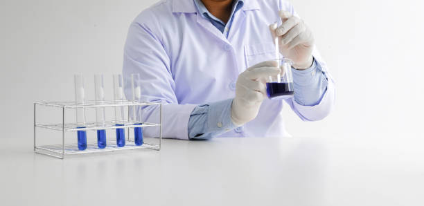 istock Science innovative Male medical or scientific laboratory researcher performs tests with blue liquid in laboratory. equipment science experiments technology Coronavirus Covid-19 vaccine research 1583174598