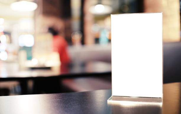 istock Menu frame standing on wood table in Bar restaurant cafe. space for text marketing promotion. 1583175165