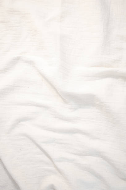 istock Fabric backdrop White linen canvas crumpled natural cotton fabric Natural handmade linen top view background Organic Eco textiles White Fabric texture 1583175879