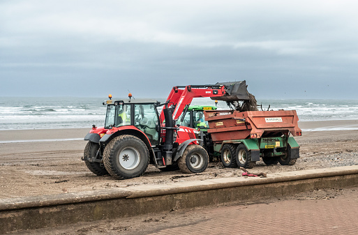 Prestwick, Scotland, UK - 9th March 2022. After a number of storms and high winds, workmen clear Prestwick Beach of seaweed, driftwood and other debris.