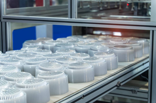 istock Stack of polypropylene food containers on conveyor belt of automatic plastic injection molding machine,automated technology concept 1583184862