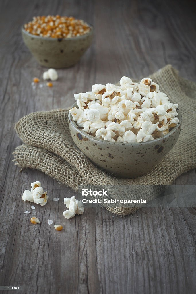 Pop corn Pop corn in a bowl on a wooden background Appetizer Stock Photo