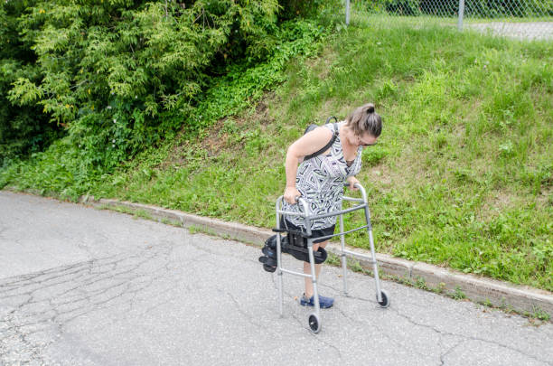 istock Mature woman climbing hill with walker 1583198387