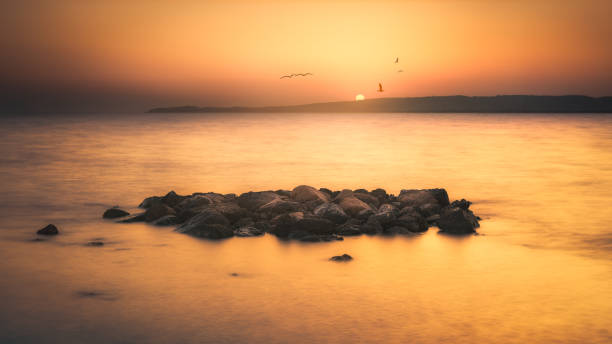 istock sea rocks landscape at sunset 1583199037