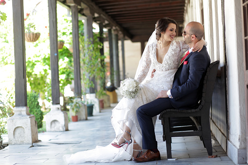 Young bridal couple posing on the bench