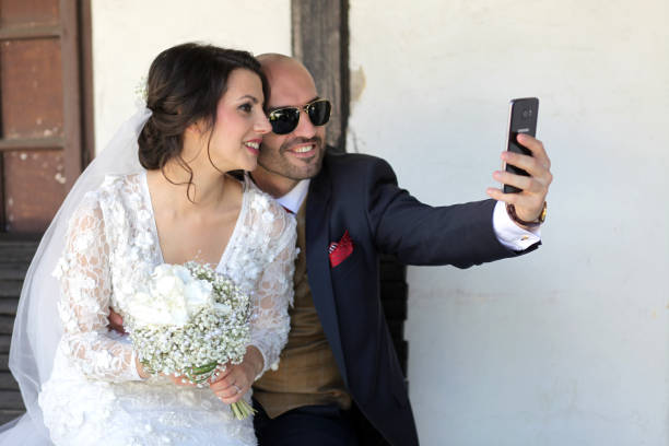 istock Wedding couple takes a selfie 1583200162