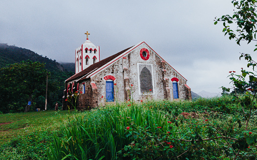 A church with a red and blue door located at Aruku valley, visakhapatnam.