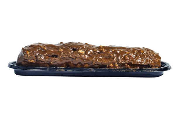 istock Traditional french dessert. Isolated eclair with custard and chocolate icing and peanuts on white background. Pastry products for sweet tooth 1583201199