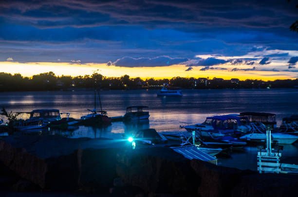 Marina with boats on Memphremagog lake during evening of summer